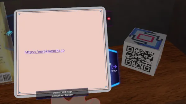 QRコードの描かれた立方体の横に「https://eurekaworks.jp」と書かれたパネルがあり、OPEN ボタンと「Opened Web Page on Desktop Browser」の表示が出ている画面