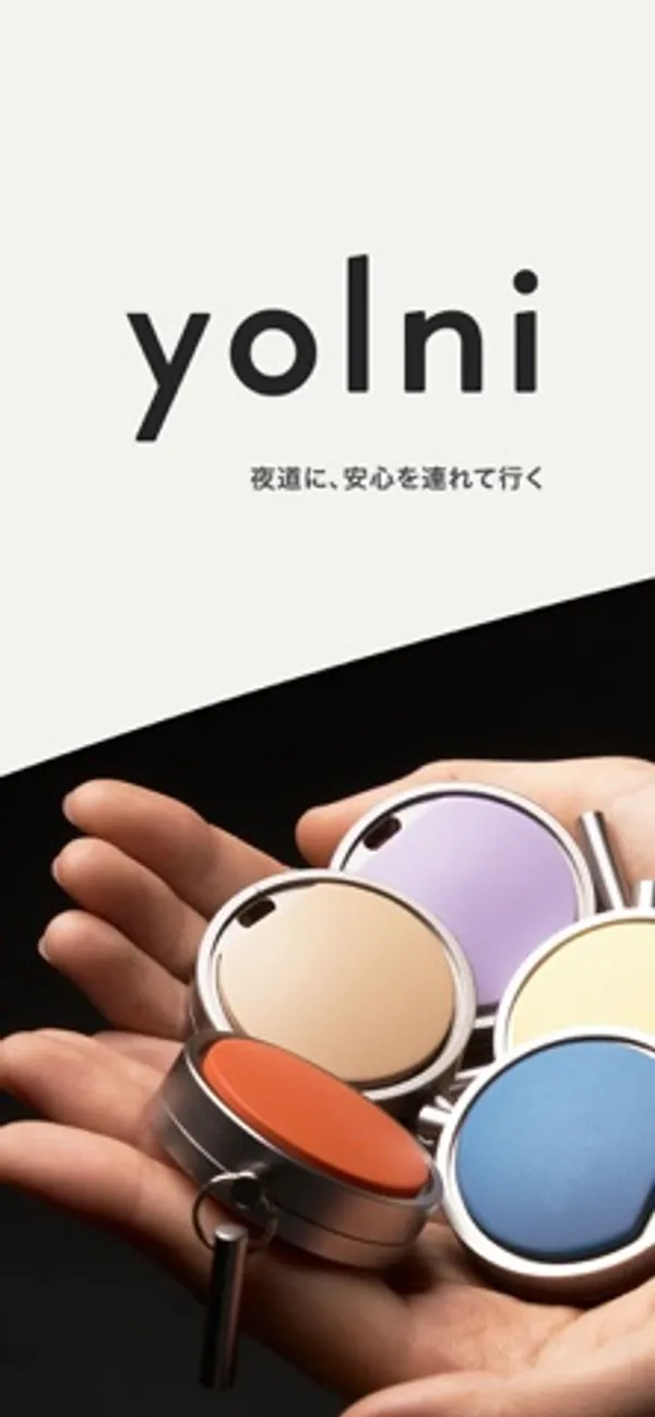yolniのロゴの下で、手のひらにオレンジ、ベージュ、紫、黄、青の丸い本体がのっている